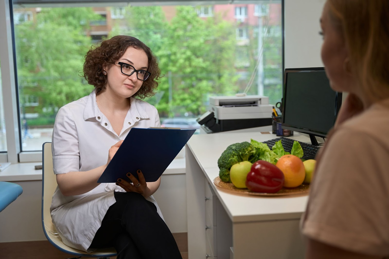 Nutrition expert discussing a personalized diet plan with a client at a wellness center.