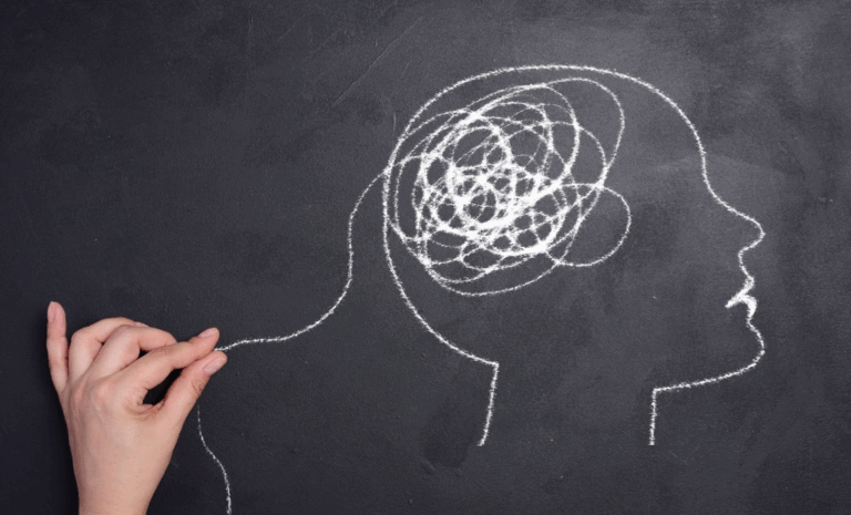 White chalk drawing of a human head with a tangled spiral in the brain area, symbolizing confusion or brain fog.