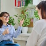 Female lifestyle coach working with a young woman during a private session in an office setting